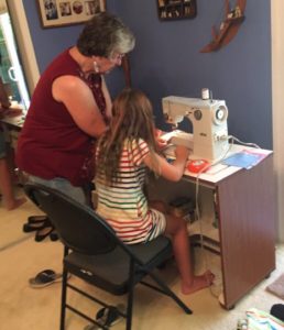 woman and girl at sewing machine