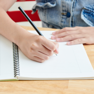 notebook with child writing 